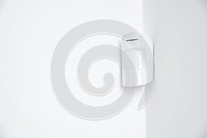 motion sensor in the white corner. device that tracks movement of objects.