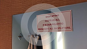 Motion of shoplifting costs us all sign on wall