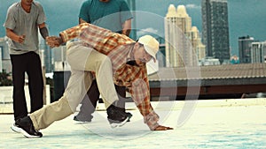 Motion shot of skilled hipster doing break dance at sky scrapper. Endeavor.