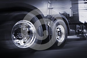 Motion speeding of semi truck. close up a truck wheels.