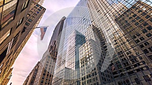 Motion timelapse of Manhattan street in Midtown, skycrapsers reflections on buildings. New York City