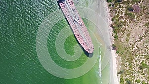 Motion from Transparent Ocean Water to Aground Tanker at Beach