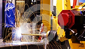 Motion Welding robots in factory with sparks, manufacturing, industry, factory