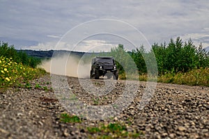 Motion the wheels tires and off-road that goes in the dust. Off road sport truck between mountains landscape. 4x4 travel