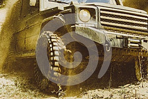 Motion the wheels tires and off-road that goes in the dust. Off-road vehicle goes on the mountain. Track on mud. 4x4 Off