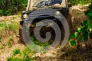 Motion the wheels tires and off-road that goes in the dust on the sand. Off-road vehicle goes on mountain way. Tires in