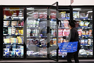 Motion of woman buying frozen fruits inside Walmart store