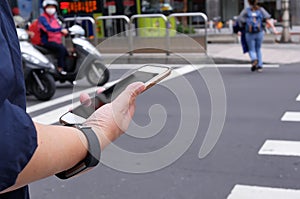 Motion of woman crossing street and holding phone