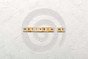 Motivate me word written on wood block. Motivate me text on cement table for your desing, concept