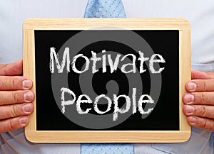 Motivate People - Businessman holding chalkboard with text