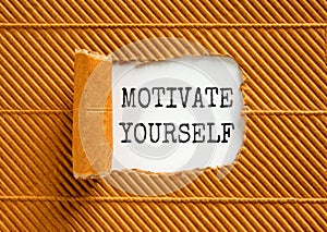 Motivate yourself symbol. Concept words Motivate yourself on beautiful white paper. Beautiful brown paper background. Business