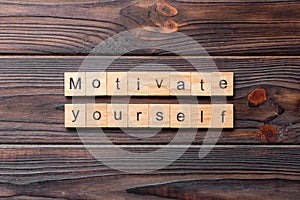 Motivate yourself word written on wood block. motivate yourself text on cement table for your desing, concept