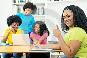 Motivated african american computer science student with group of coding students