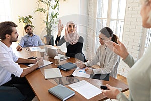Motivated Arabic female employee participate in group discussion photo