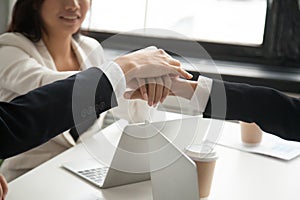 Motivated business people put hands together, loyalty engagement