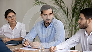 Motivated diverse employees brainstorm discuss ideas at meeting