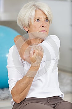 motivated elderly lady doing fitness exercises