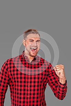 Motivated enthusiastic man cheering pumping air