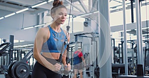 motivated fitenss woman pulling exercise equipment in gym