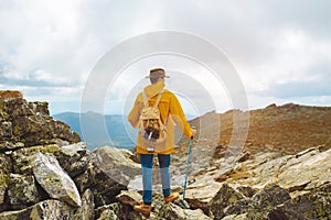 Motivated hiker at the top of a rock with backpack enjoy autumn day