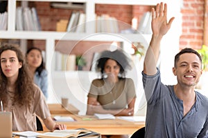 Motivated male student ask hand asking question at lesson