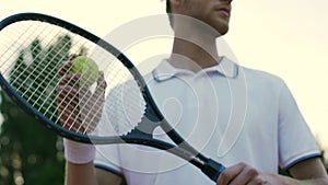 Motivated sportsman holding racket, preparing to serve tennis ball, sport