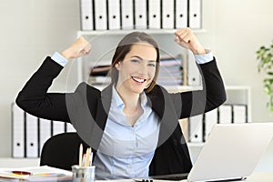 Motivated businesswoman looking at camera at office photo