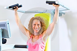 Motivated woman using weight machine