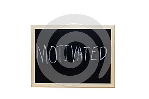 MOTIVATED written with white chalk on blackboard