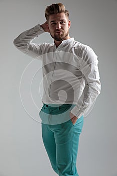 Motivated young man standing and posing relaxed