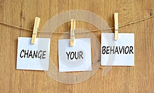 Motivation and Change your behavior symbol. Concept words Change your behavior on white paper on a beautiful wooden table wooden