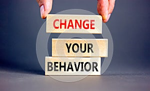 Motivation and Change your behavior symbol. Concept words Change your behavior on wooden block on a beautiful grey table grey