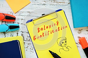 Motivation concept meaning Delaying Gratification with phrase on the piece of paper photo