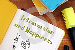 Motivation concept meaning Introversion and Happiness with inscription on the sheet photo