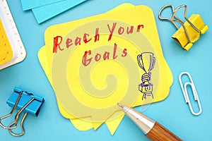 Motivation concept meaning Reach Your Goals with sign on the sheet