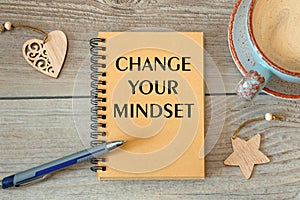 Motivation encouragement quote written on notepad - CHANGE YOUR MINDSET