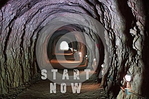 Motivation and Growth. Start Now. Words Written in a Tunnel with Light at the Exit