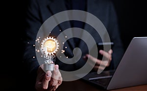 Motivation and innovation, Businessman holding light bulb with brain icon and gears inside. glowing light, idea innovation and