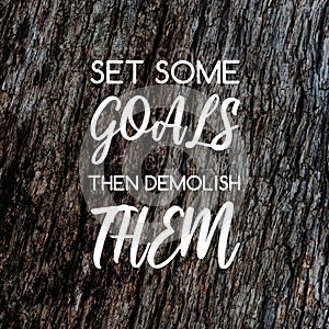 Inspirational quotes - Set some goals the demolish them. Blurry background photo