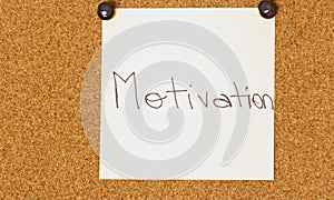 Motivation post-it on a coarkboard background