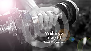 Motivation quote - Wake up, stay fit and trust the process. With person holding dumbbell in hand, lifting weights.