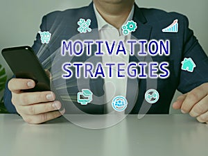 MOTIVATION STRATEGIES text in search bar. Manager looking at cellphone