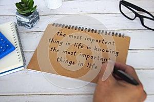 Motivational and inspirational quote about the most important thing in life. With hand writing on brown paper notepad