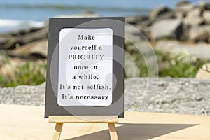 Motivational and Inspirational quote on a notepad with blurred beach background