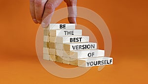 Motivational and inspirational symbol. Wood blocks with words Be the best version of yourself. Beautiful orange background