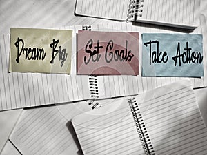 Motivational and inspirational text - DREAM BIG SET GOALS TAKE ACTION background. Stock photo.