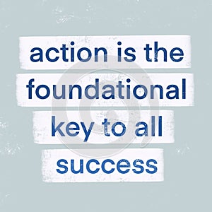 A motivational quote, "ACTION IS THE FOUNDATIONAL KEY TO ALL SUCCESS " isolated on pastel blue background.