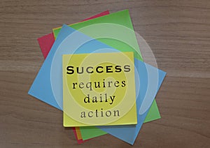 Motivational quote on colorful notepad on wooden background