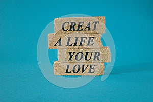 Motivational quote Create a life you love written on brick block. Beautiful blue background. Business concept.