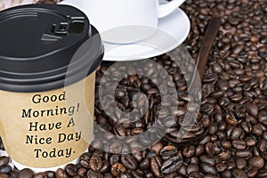 Motivational quote on disposable coffee cup on coffee beans background
